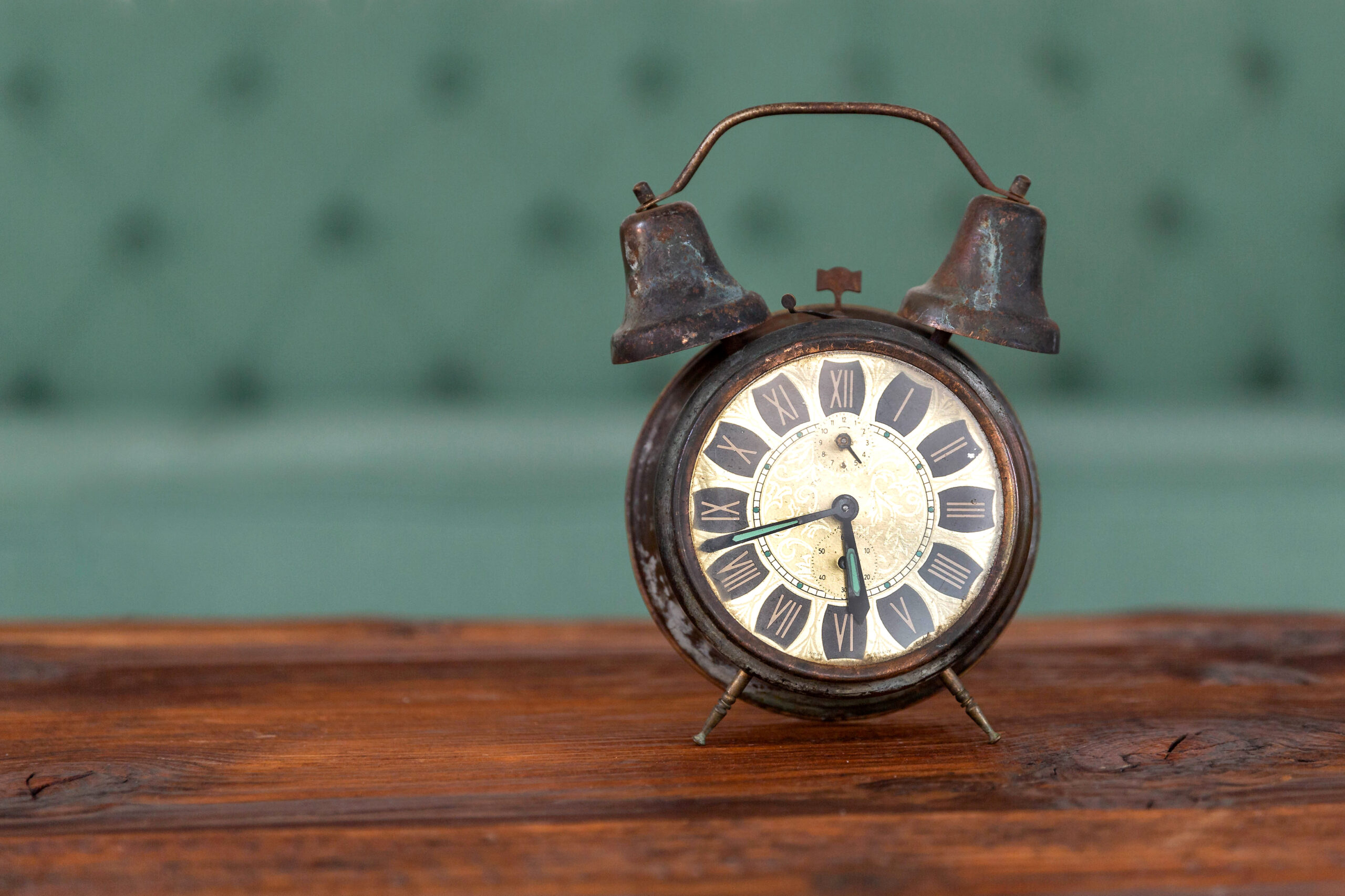 Retro alarm clock on the wooden table